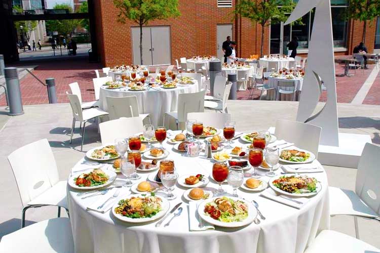 Empty table in the courtyard with plated food displayed