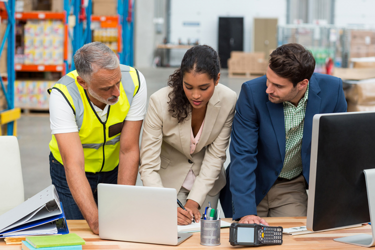 Supply chain professionals collaborating in warehouse