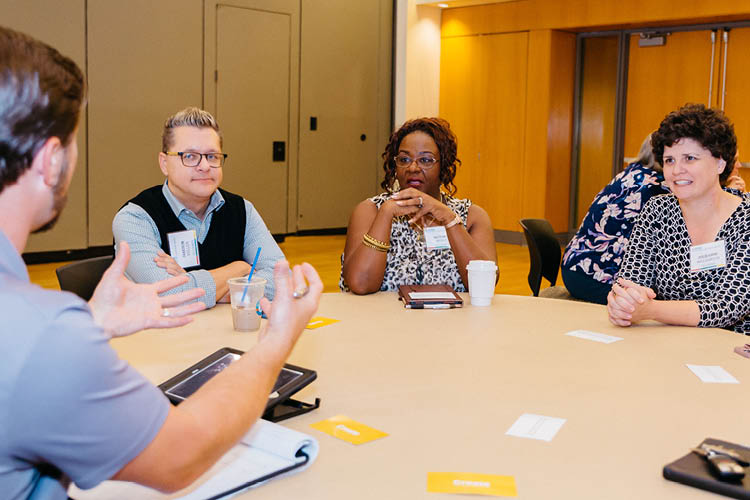 ASPIRE participants sitting around a table during a discussion