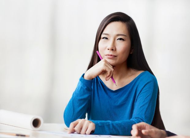 Woman sitting and thinking about her professional goals and how to achieve them.