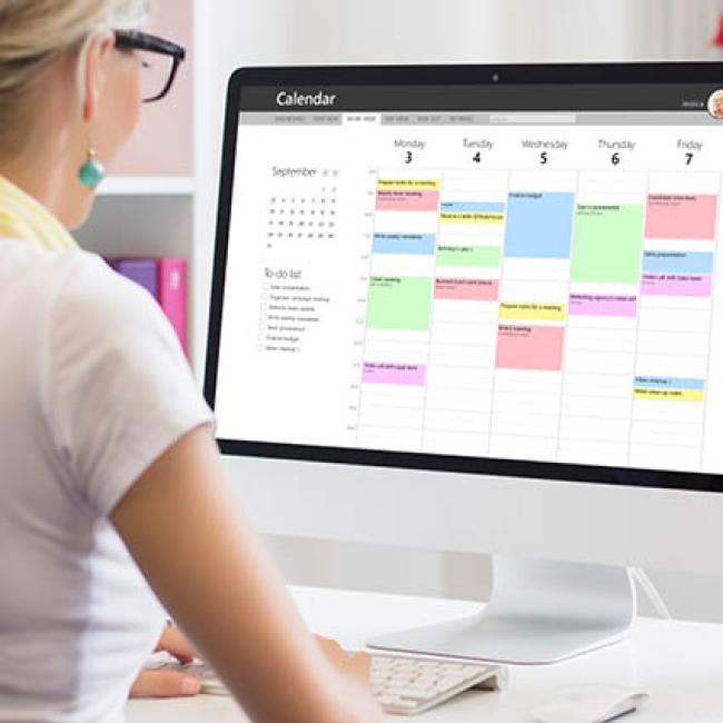 Female professional blocking off focus time on work calendar