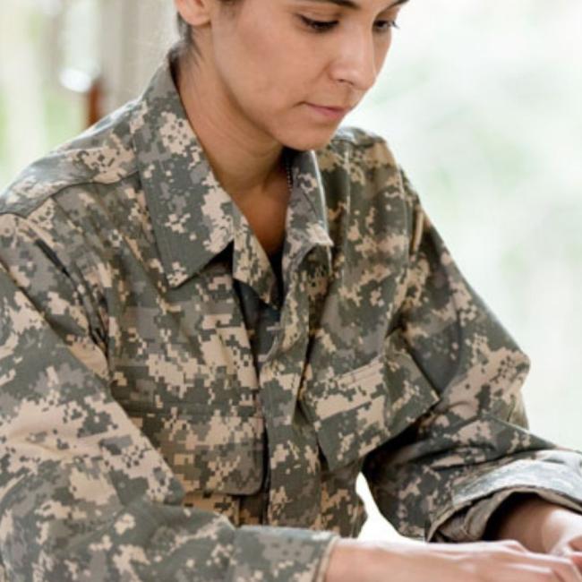 Female solider learning on laptop
